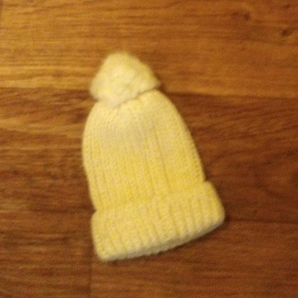Yellow pom pom beanie